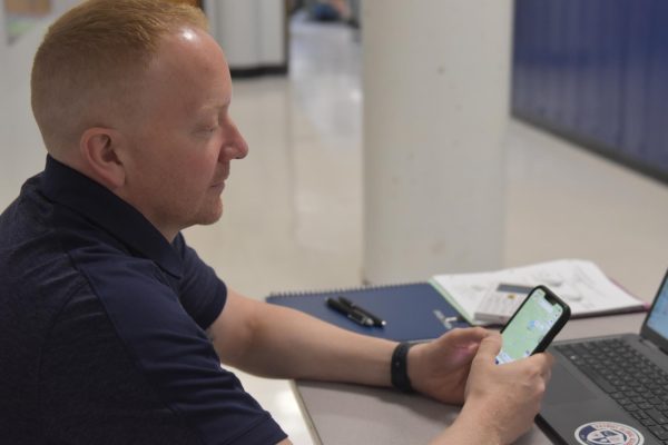 PGA math teacher Rodney Holtmeyer checks his Life360 app. Holtmeyer shares Life360 with all of his family members, including his mother and sister.