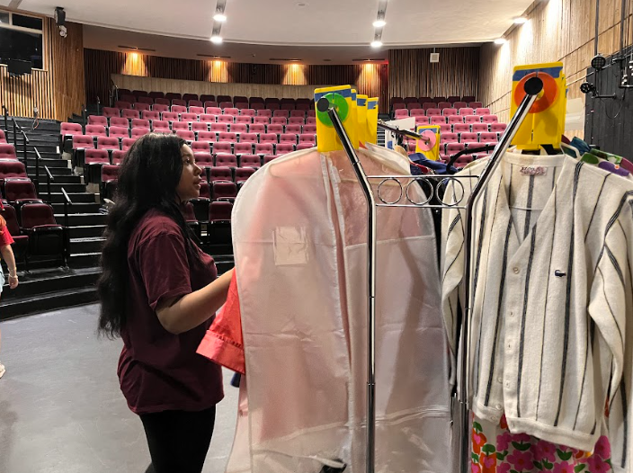 Senior Dasia Dantzler helps organize the costumes for the Senior One Acts. Dantzler's play was "Will You Be My Nemesis?"